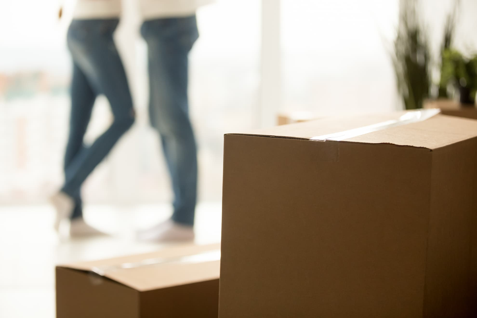 close up millennial couple moving new home with boxes 2